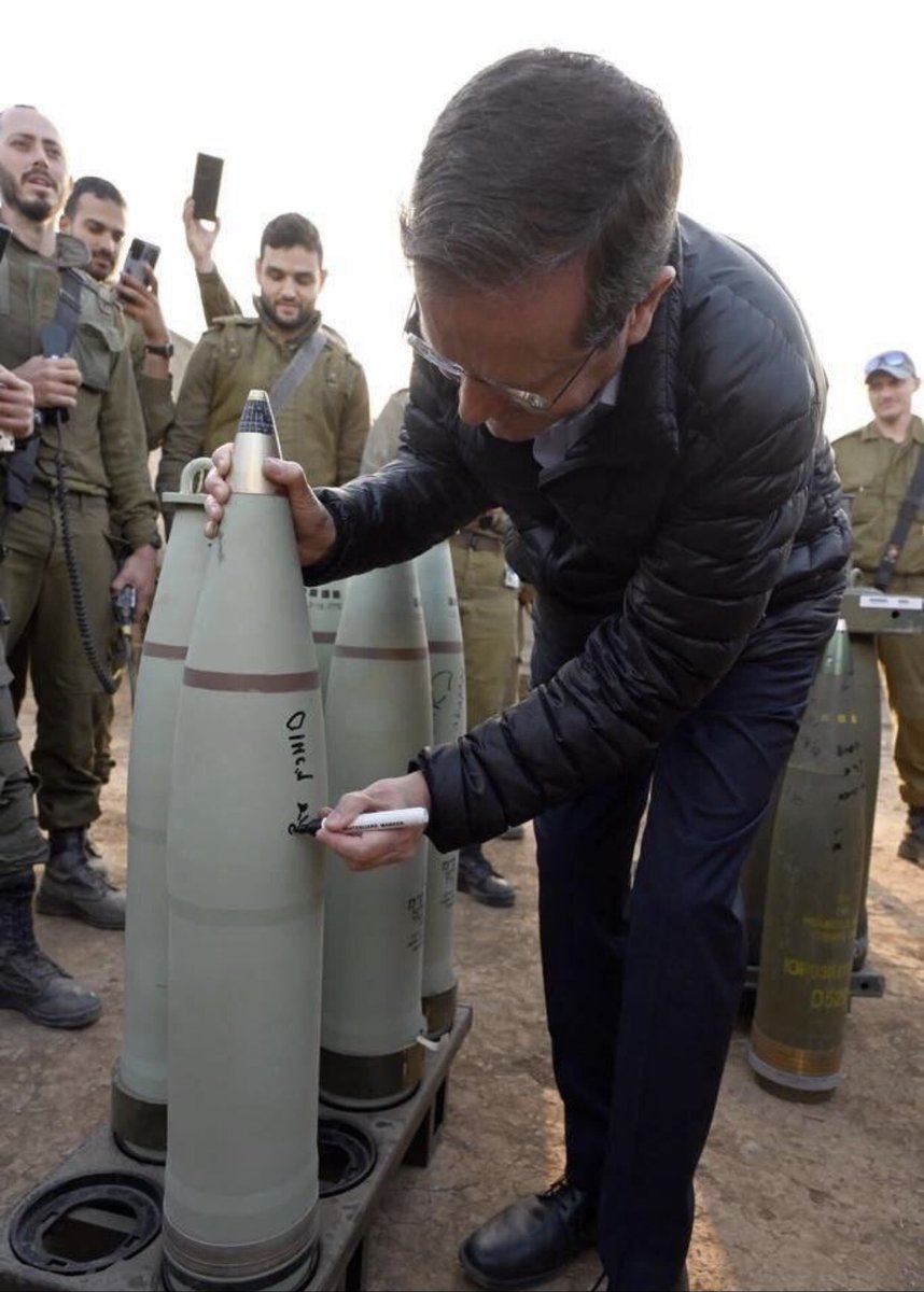 Isaac Herzog photographed signing artillery shells destined for Gaza